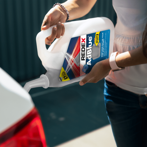 Female pouring Redex Adblue 5L into car tank