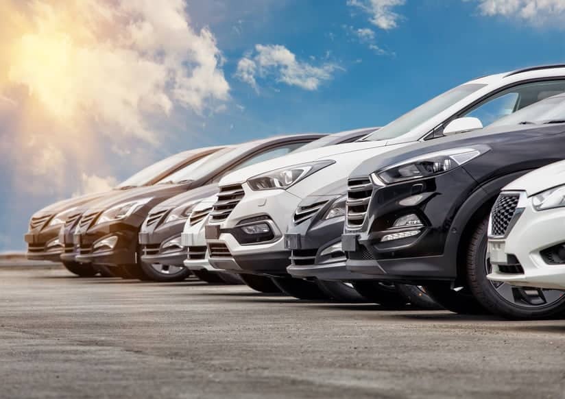 Cars lined up together with the sky in the background