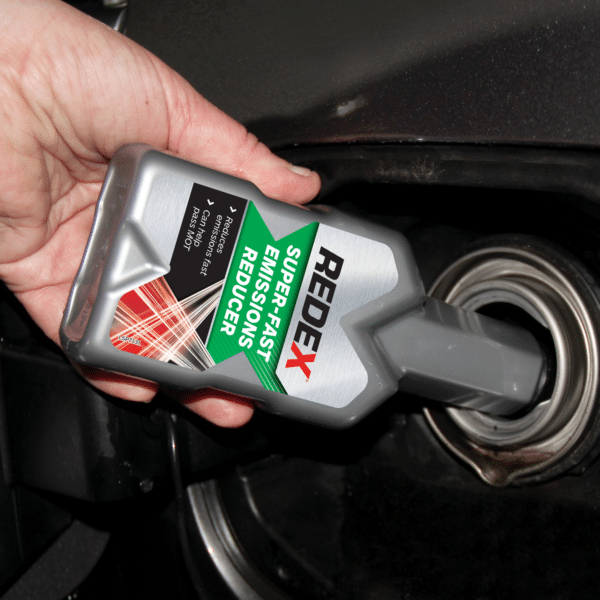 Redex super fast emissions reducer petrol being poured into fuel tank.